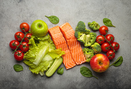 Fresh raw healthy food vegetables fruit salmon fillet grey background, inflammatory diet, clean eatingの写真素材