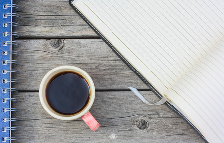 cup of coffee on wood background with bookの写真素材
