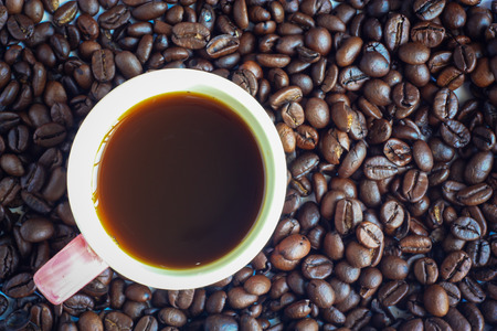 cup of coffee on the coffee beans backgroundの写真素材