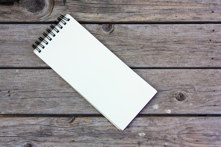paper note on old wood backgroundの写真素材