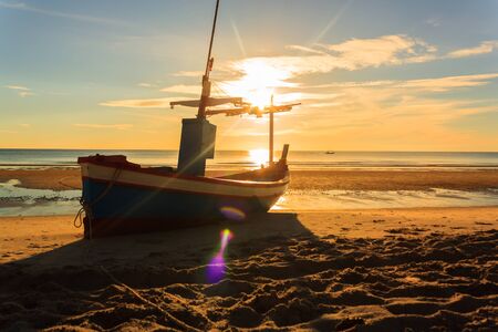 fishing boat on Huahin beach in the morning in rainy season ,Thailandの写真素材