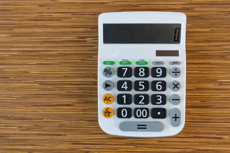 calculator on brown wood tableの写真素材