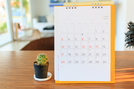 calendar page on table with office backgroundの写真素材