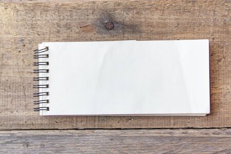 paper note on old wood backgroundの写真素材