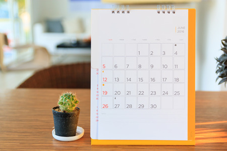 calendar page on table with office backgroundの写真素材