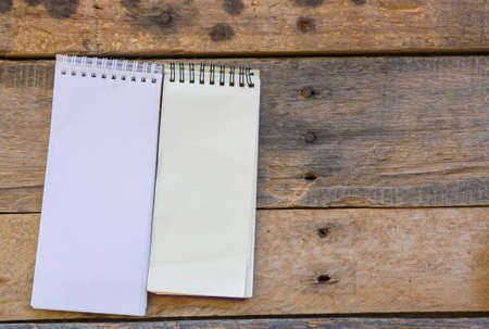 paper note on old wood backgroundの写真素材