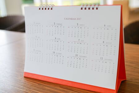 calendar page on table with office backgroundの写真素材