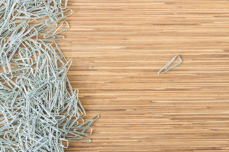 group of paper clips on wooden table backgroundの写真素材