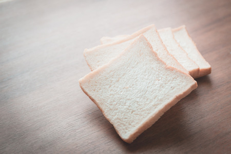 slice of bread on wooden table backgroundの写真素材