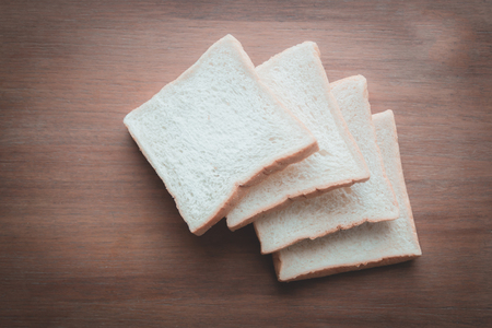 slice of bread on wooden table backgroundの写真素材