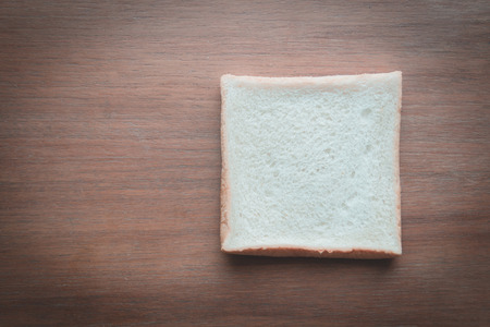 slice of bread on wooden table backgroundの写真素材