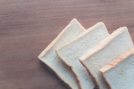 slice of bread on wooden table backgroundの写真素材