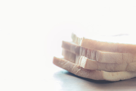 slice of bread on wooden table backgroundの写真素材