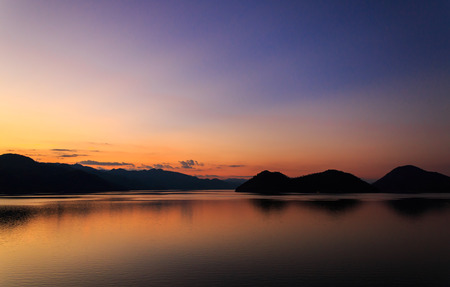 scenery of lake and mountain in  the evening at Srinagarind dam, Kanchanaburi ,Thailandの写真素材
