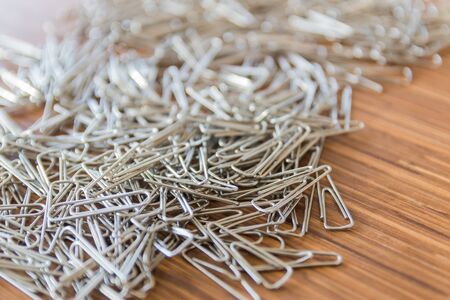 group of paper clips on wooden table backgroundの写真素材