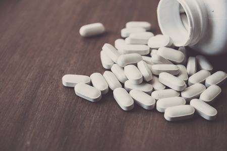 medicine pill on wood table (Selective Focus)の写真素材