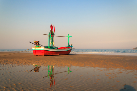 fishing boat waiting on the beach for high tide : Hua Hin  Thailandの写真素材