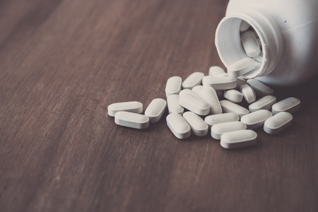 medicine pill on wood table (Selective Focus)の写真素材