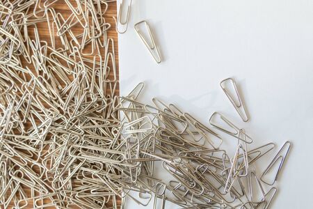 group of paper clips on wooden table backgroundの写真素材