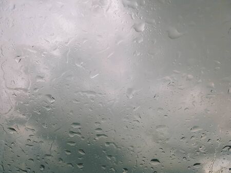 rain droplet on car window on drak backgroundの写真素材