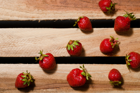 A few berries ripe strawberries on wooden plates, empty space, top viewの写真素材