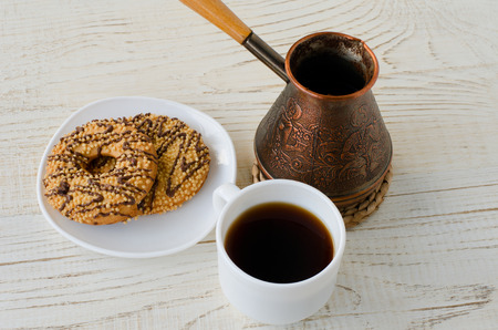 Top view of a cup of coffee, cookies and a coffee potの写真素材