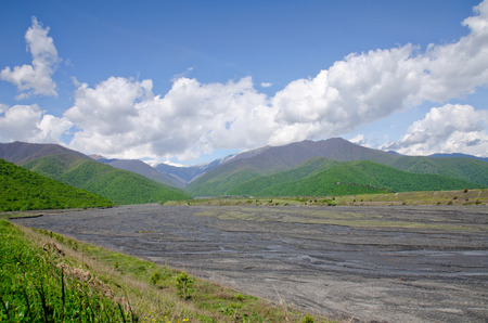 Valley not affluent mountain river among green hills. Caucasus, Georgia