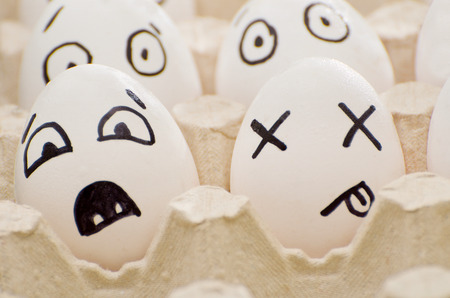 Two eggs with painted emotions: fear and deathの写真素材