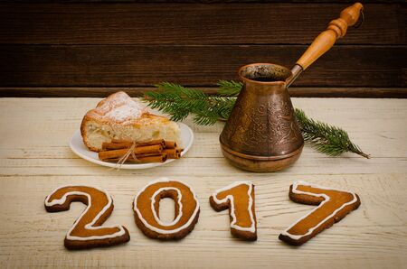 Inscription 2017 from gingerbread, apple pie, Cezve and spruce twigs on a wooden backgroundの写真素材