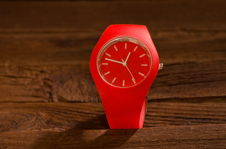Red sport watch on a wooden backgroundの写真素材