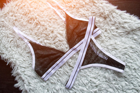 Set of black lace lingerie on a gray fur. Fashionable conceptの写真素材