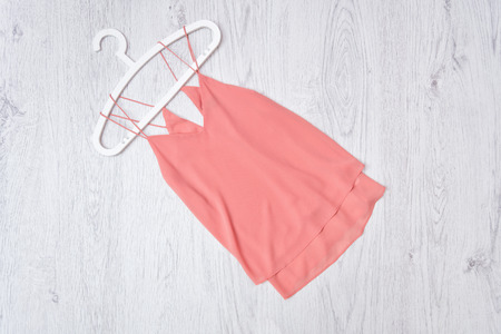 Pink top and white trempel on a wooden background. Fashionable conceptの写真素材