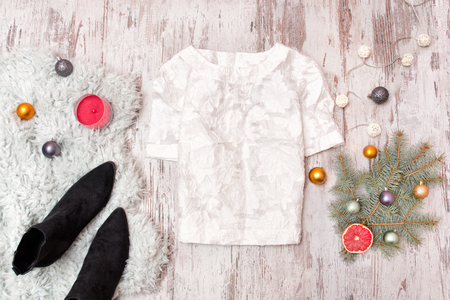 White blouse, shoes and  decorated fir branch on wooden background. Fashionable concept.の写真素材