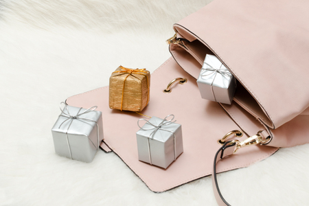 Pink handbag with small gift boxes. Holiday conceptの写真素材