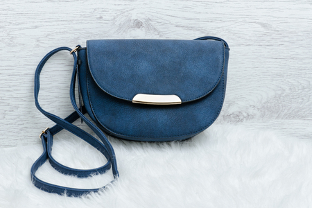 Blue handbag on a white fur. Fashion conceptの写真素材
