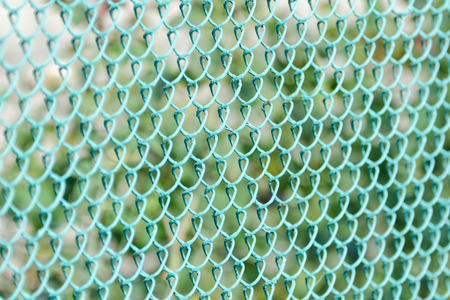 Green fence, side view. Green Backgroundの写真素材