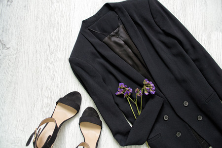 Black jacket, shoes and wild flowers. Fashionable conceptの写真素材