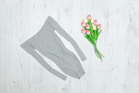 Gray body and bouquet of tulips. Fashionable conceptの写真素材
