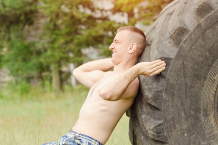 Man push a big tire. Street workoutの写真素材
