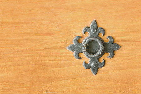 Wrought metal ring on a wooden door. Close upの写真素材