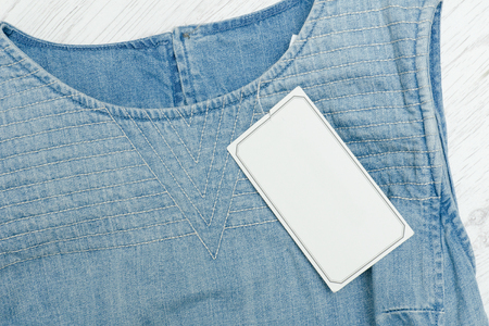 Empty white tag of blue clothes. Close-upの写真素材