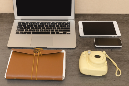 Laptop Keyboard, yellow camera, notebook, tablet and smartphone. Workplaceの写真素材