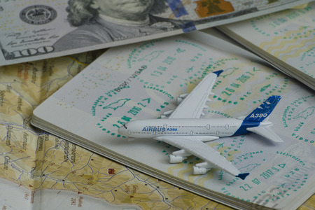 KHARKOV, UKRAINE- 13 APRIL 2018: Airplane and passport with a visa. Dollar and mapのeditorial素材