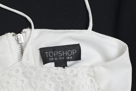 KHARKOV, UKRAINE- 29 JUNE 2018: Black tag of white clothes TOPSHOP. Close up