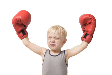 Funny blond boy in red boxing gloves. Sports concept. Isolateの写真素材