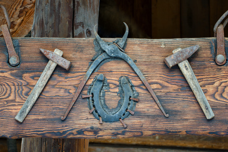 Old tools nailed to a wooden board. Exhibition