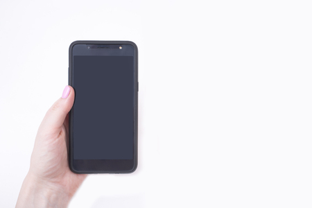 Gentle pink manicure. Female hands with a smartphoneの写真素材