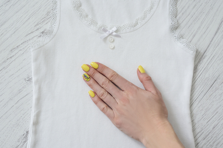 White lace tank top and female hand. Details, close up. Fashionable conceptの写真素材