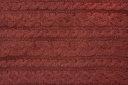 Brown knitted fabric, pigtail. Close-up