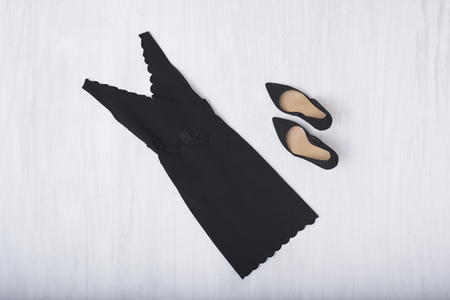 Little black dress and shoes on wooden background. Fashionable conceptの写真素材